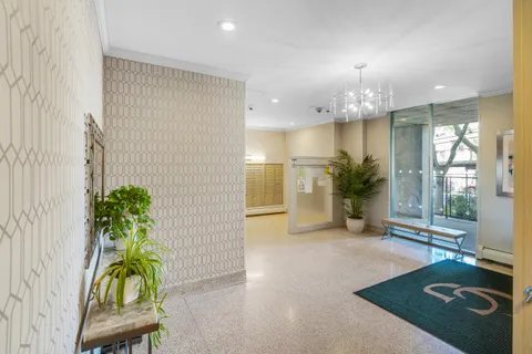 a view of a lobby with furniture and a potted plant