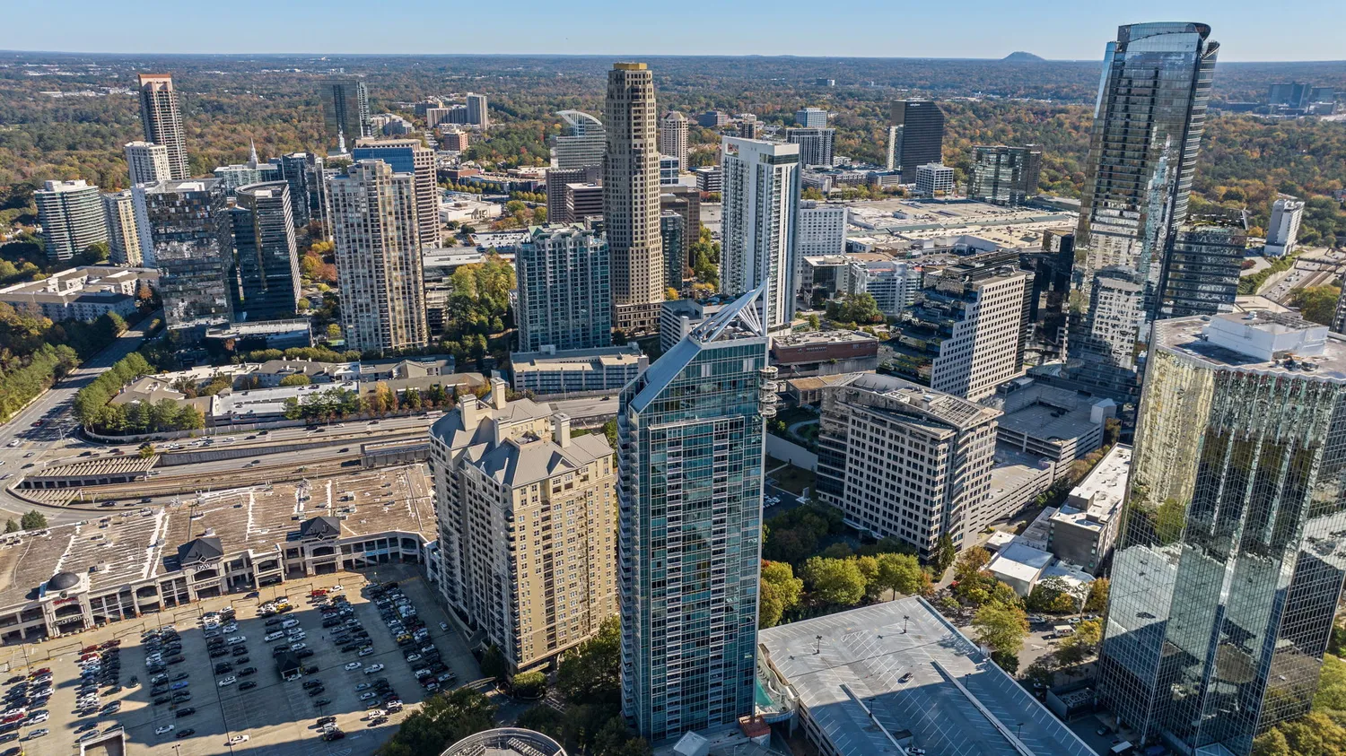a dining room with furniture a chandelier and wooden floor