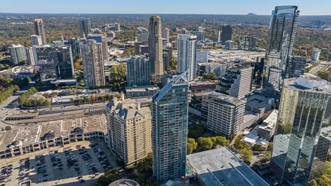 a dining room with furniture a chandelier and wooden floor