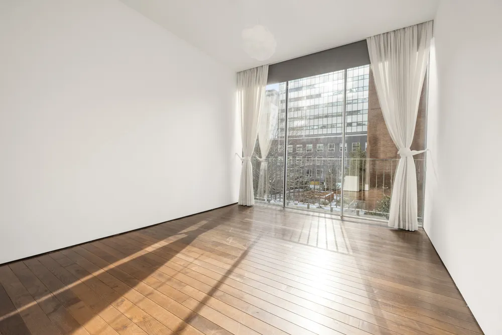 a view of a room with wooden floor and outdoor space