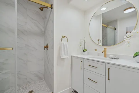 a white toilet sitting next to a bathroom shower