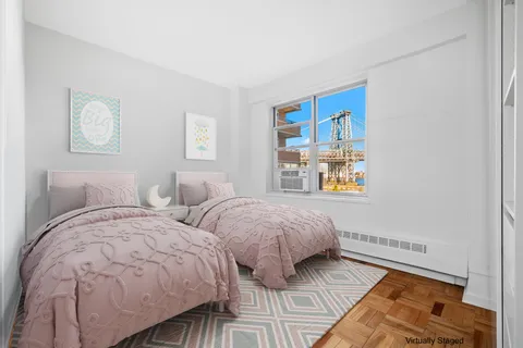 a bedroom with two beds and a window