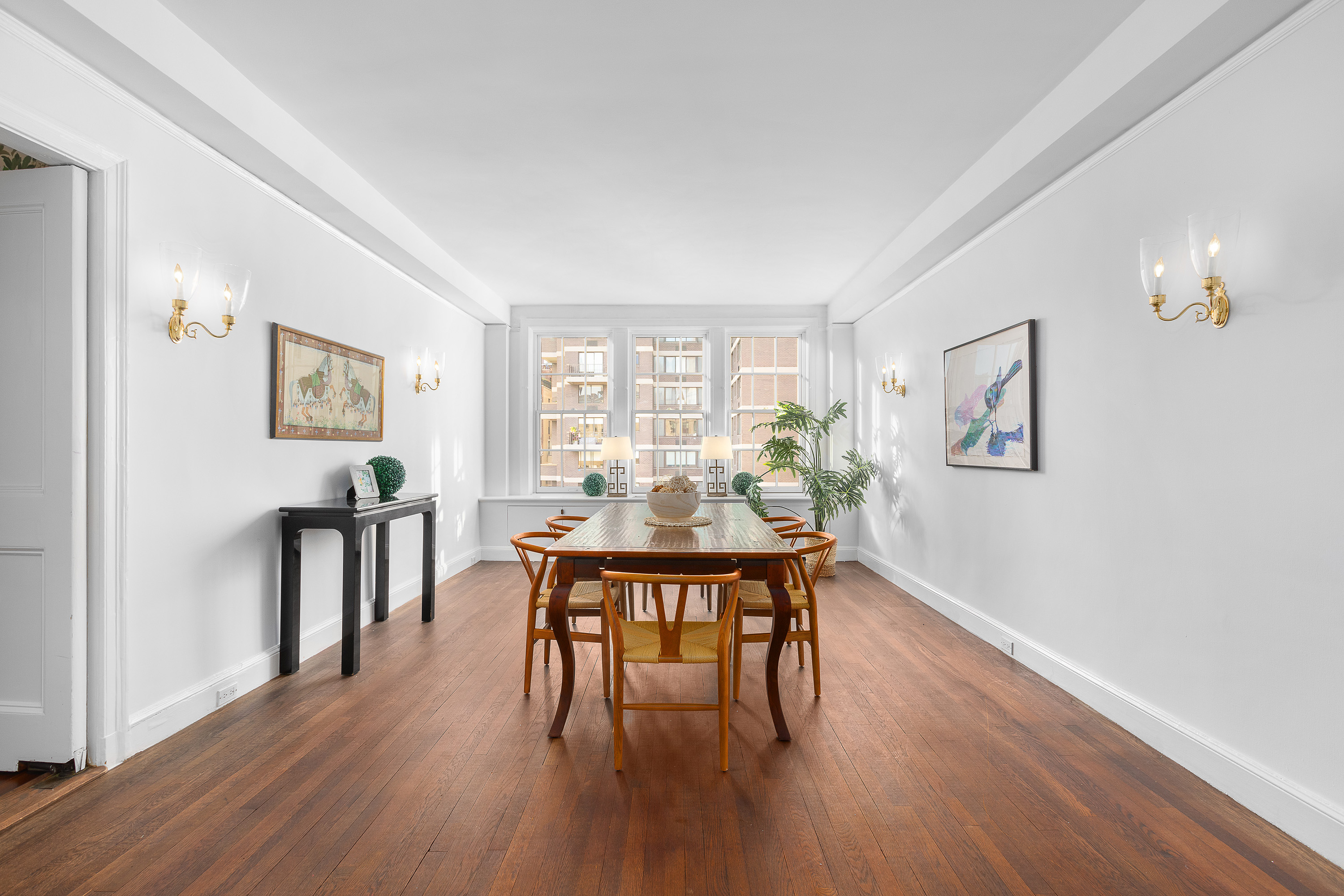 1088 Park Avenue, Unit 15C Manhattan, NY 10128 - Photo 7 of 26 a view of a dining room with furniture and wooden floor