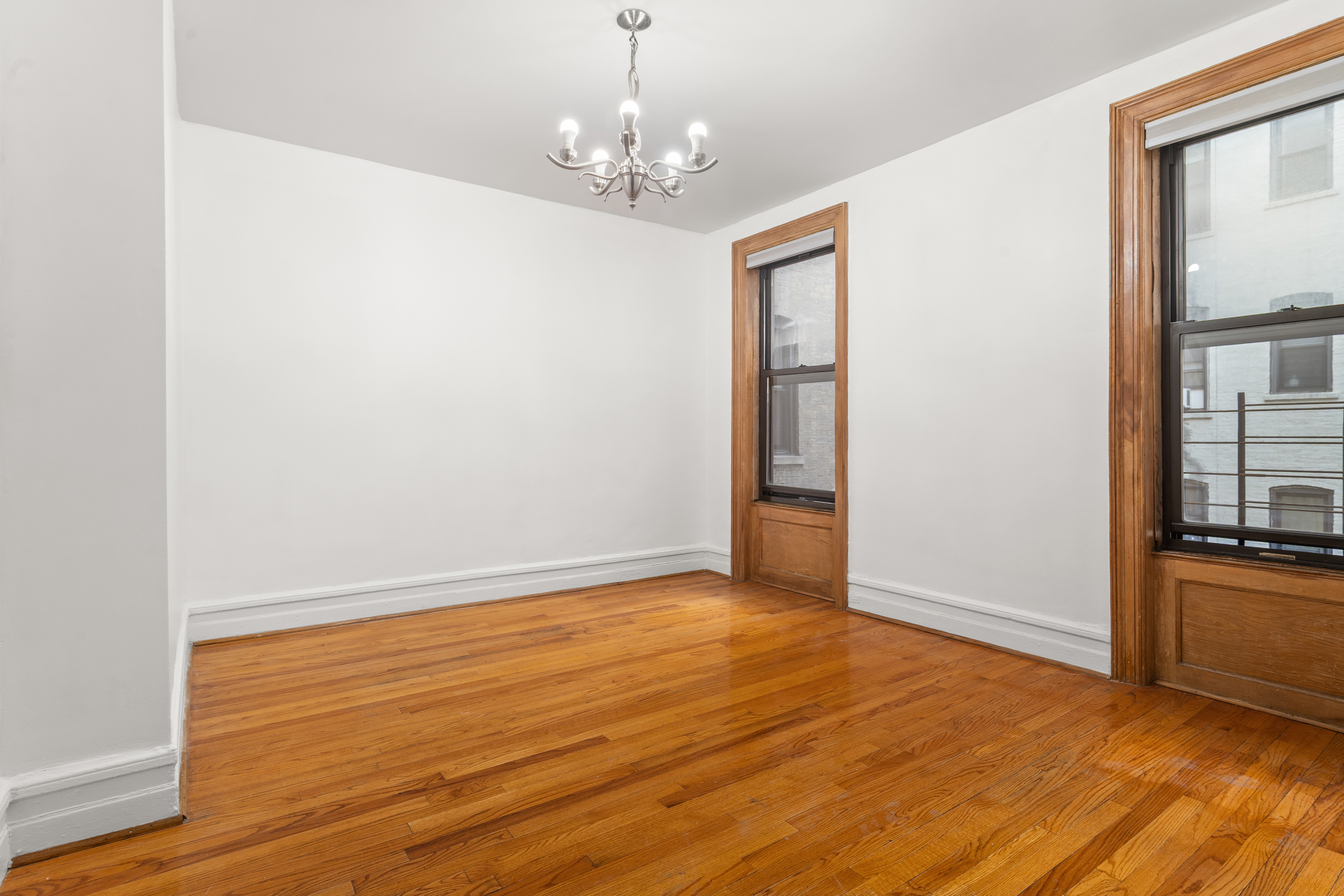 527 West 143rd Street, Unit 31 Manhattan, NY 10031 - Photo 12 of 29 wooden floor in an empty room with a window