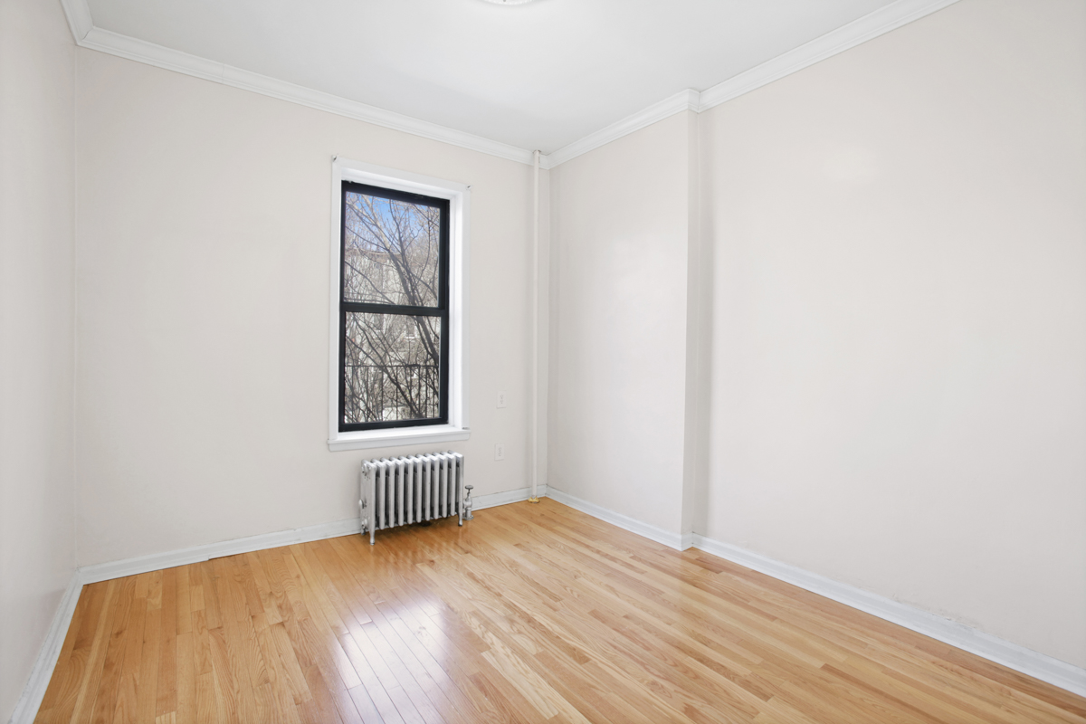 155 Garfield Place, Unit 3B Brooklyn, NY 11215 - Photo 3 of 6 an empty room with wooden floor and windows