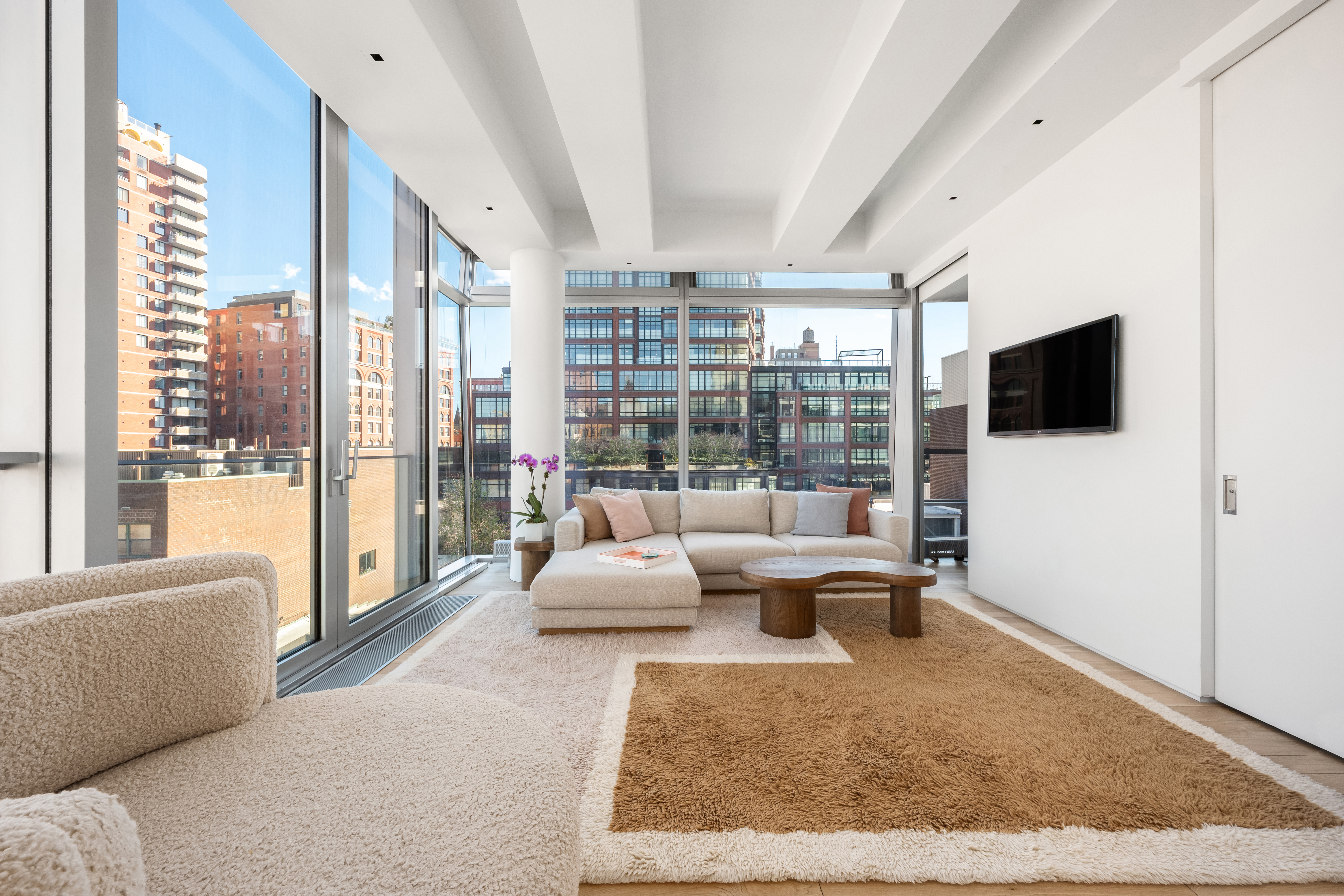 166 Perry Street, Unit 6B Manhattan, NY 10014 - Photo 2 of 17 a living room with furniture tv and a large window