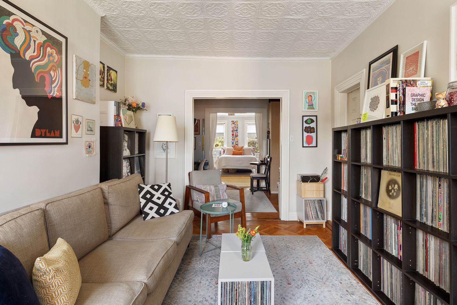 a living room with furniture and a book shelf
