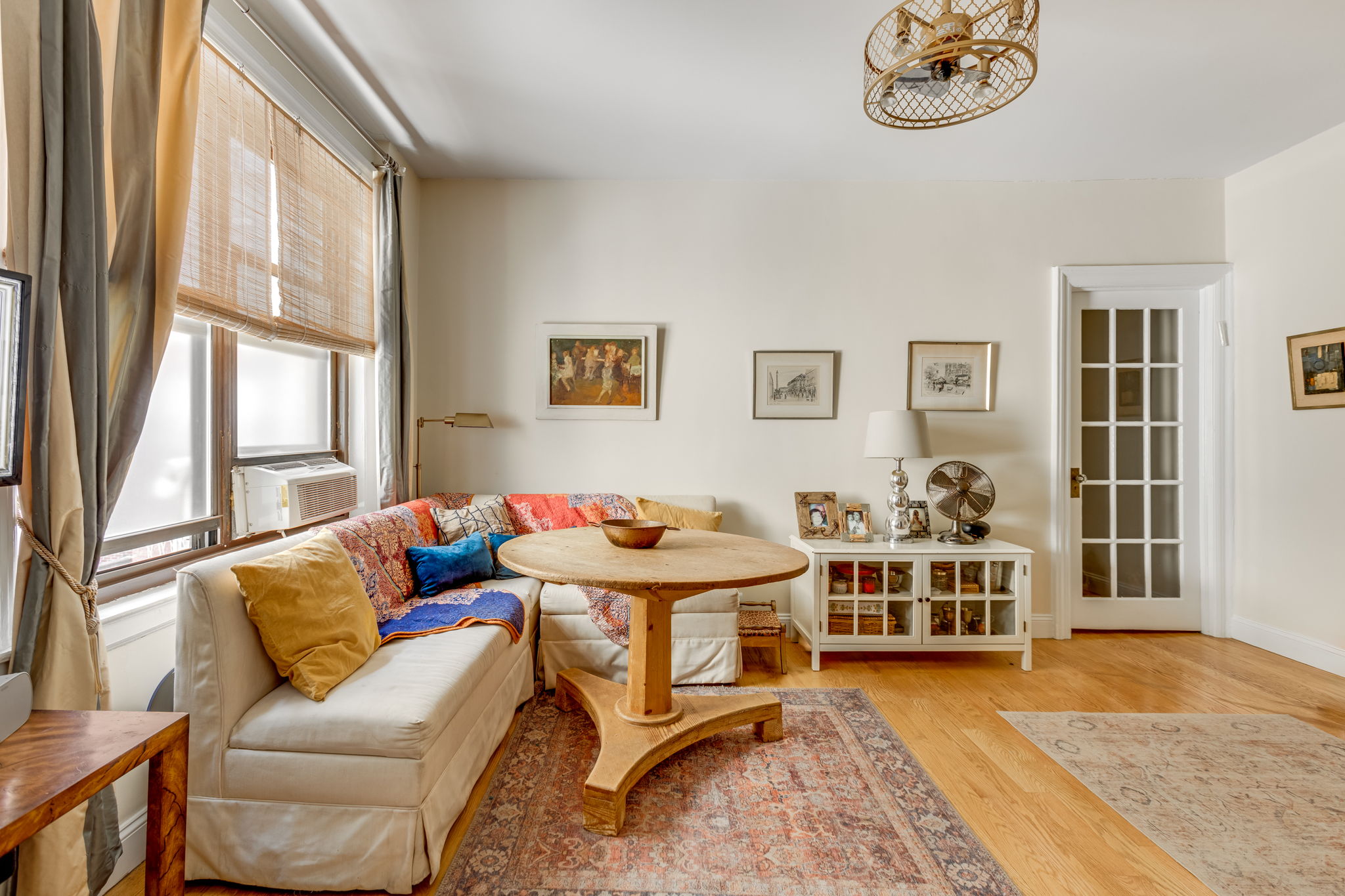 a living room with furniture a rug and a window