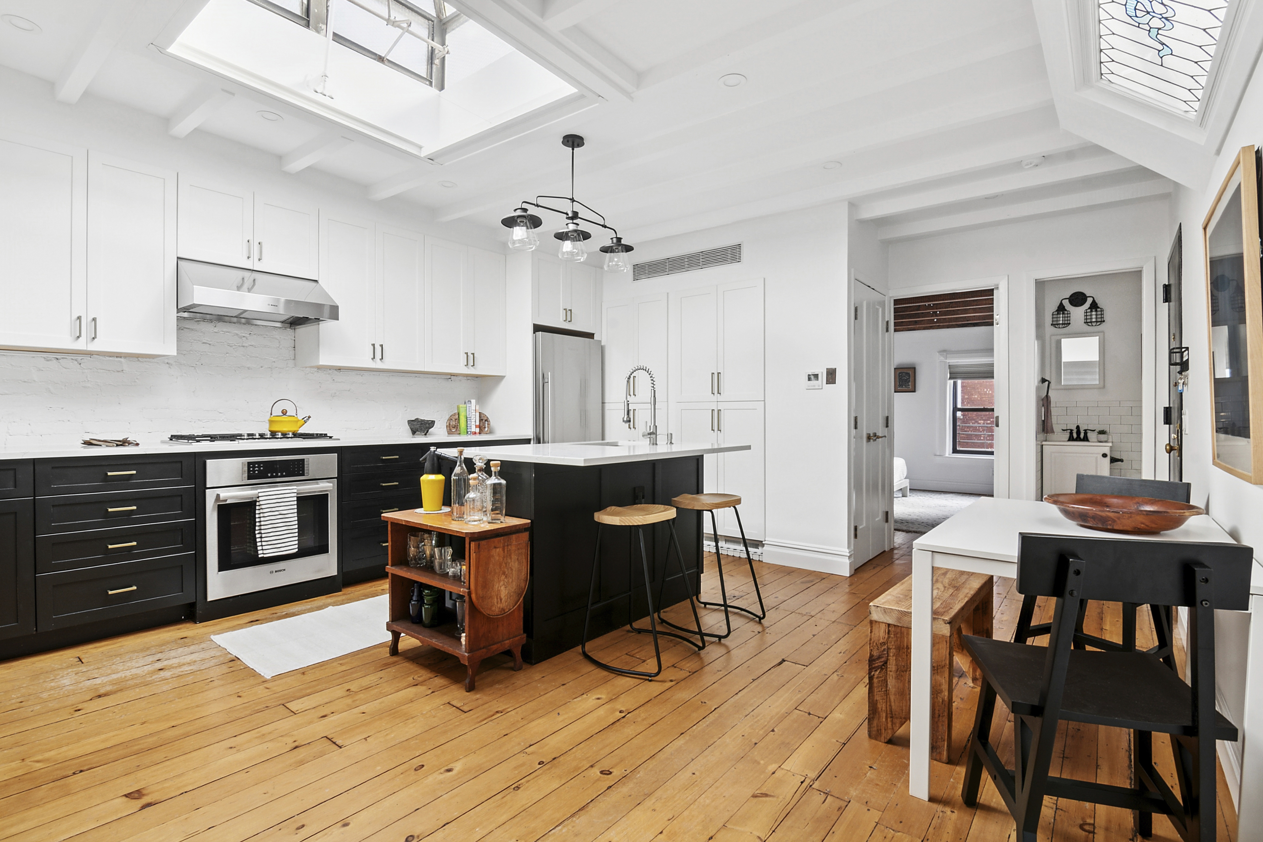 a living room with kitchen island furniture and wooden floor