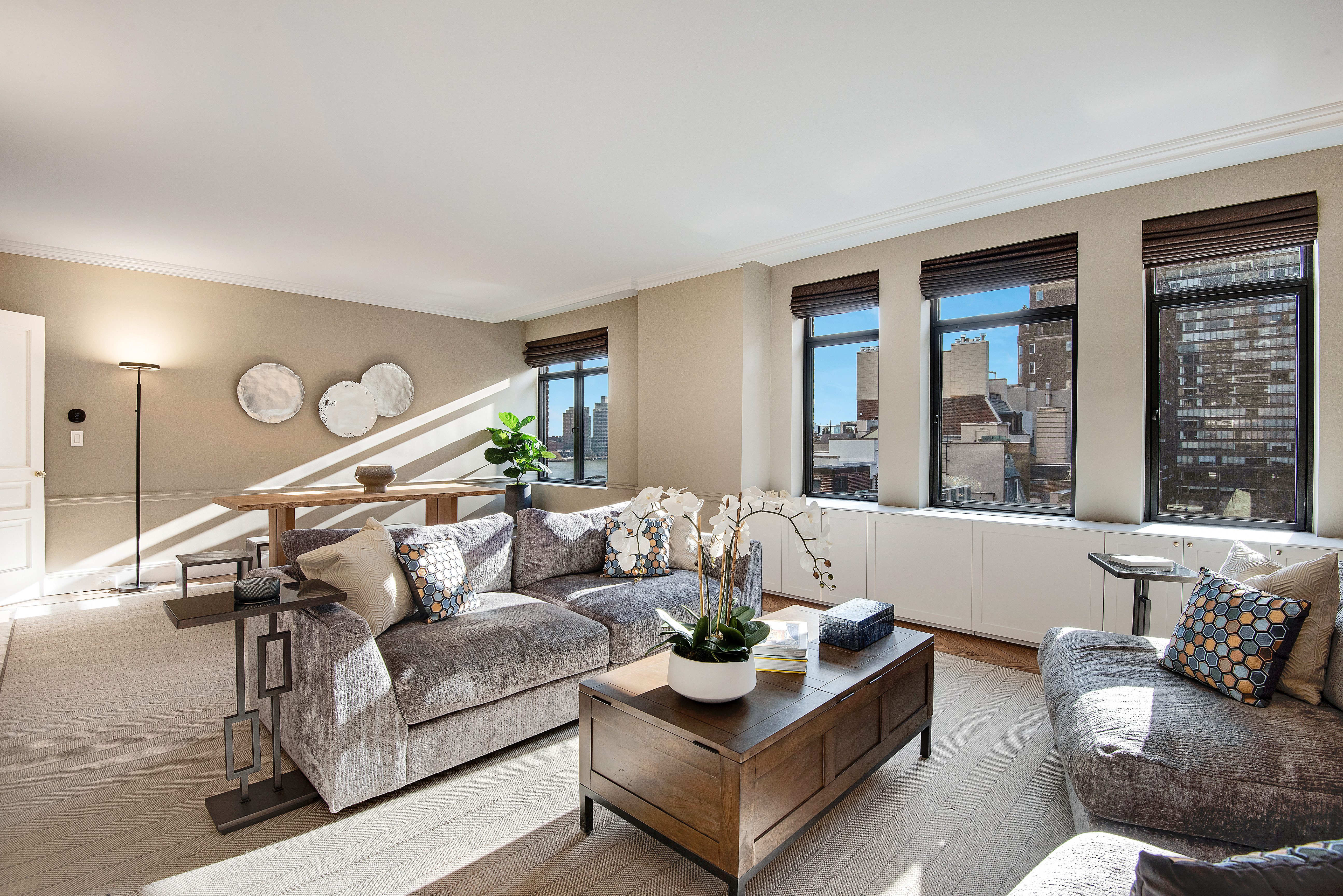 439 East 51st Street, Unit 8A Manhattan, NY 10022 - Photo 2 of 13 a living room with furniture and a large window