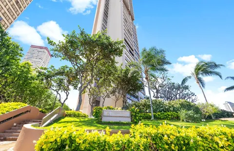 a front view of a house with a yard and fountain