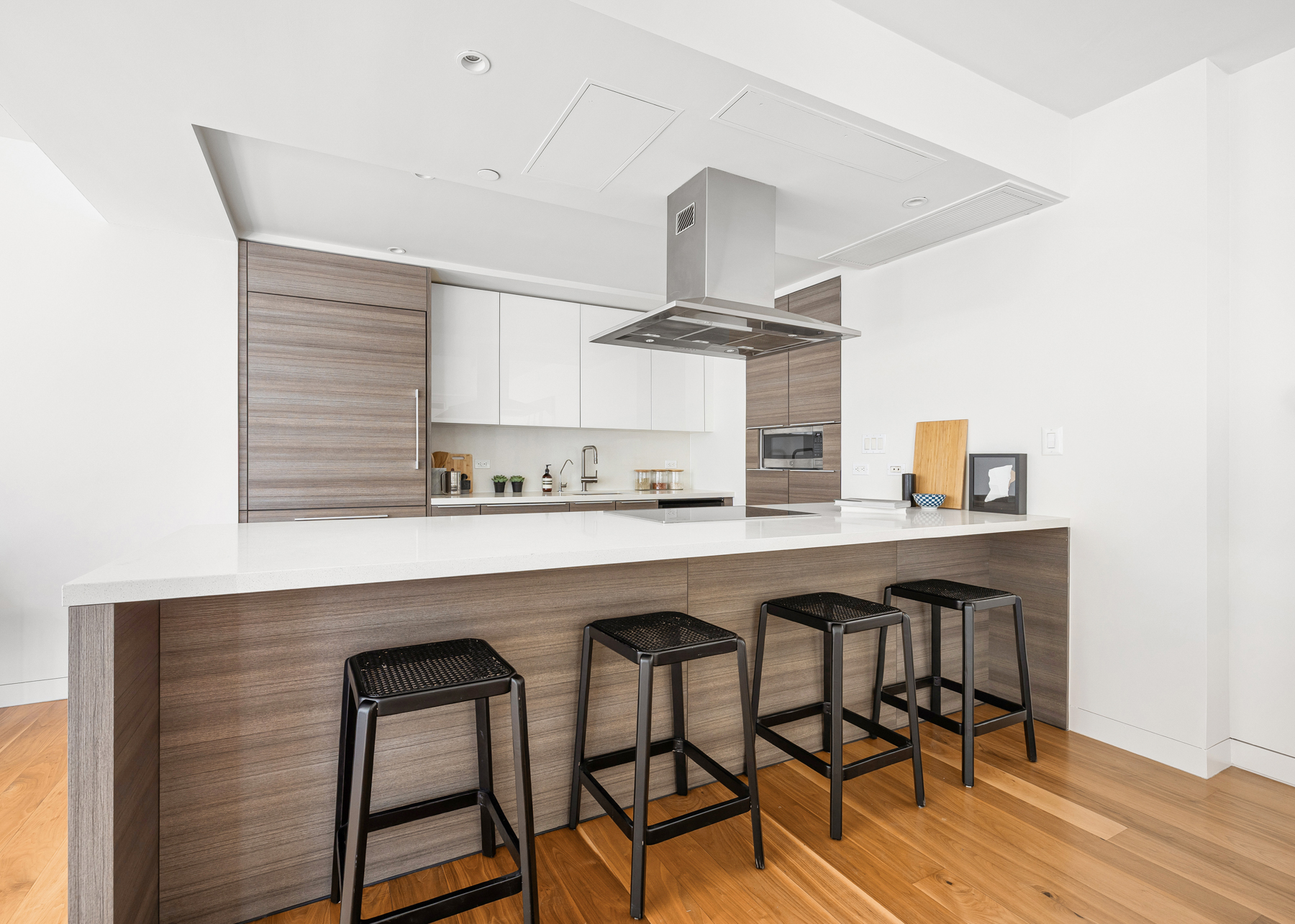 151 West 21st Street, Unit 10A Manhattan, NY 10011 - Photo 9 of 26 a kitchen with a table chairs sink and cabinets