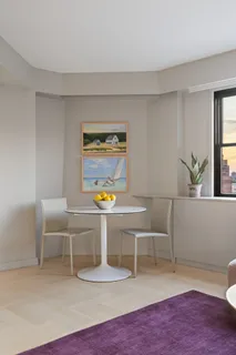 a living room with a table and chairs