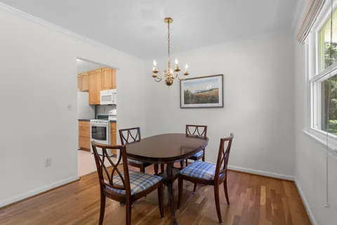 a view of a dining room with furniture and chandelier