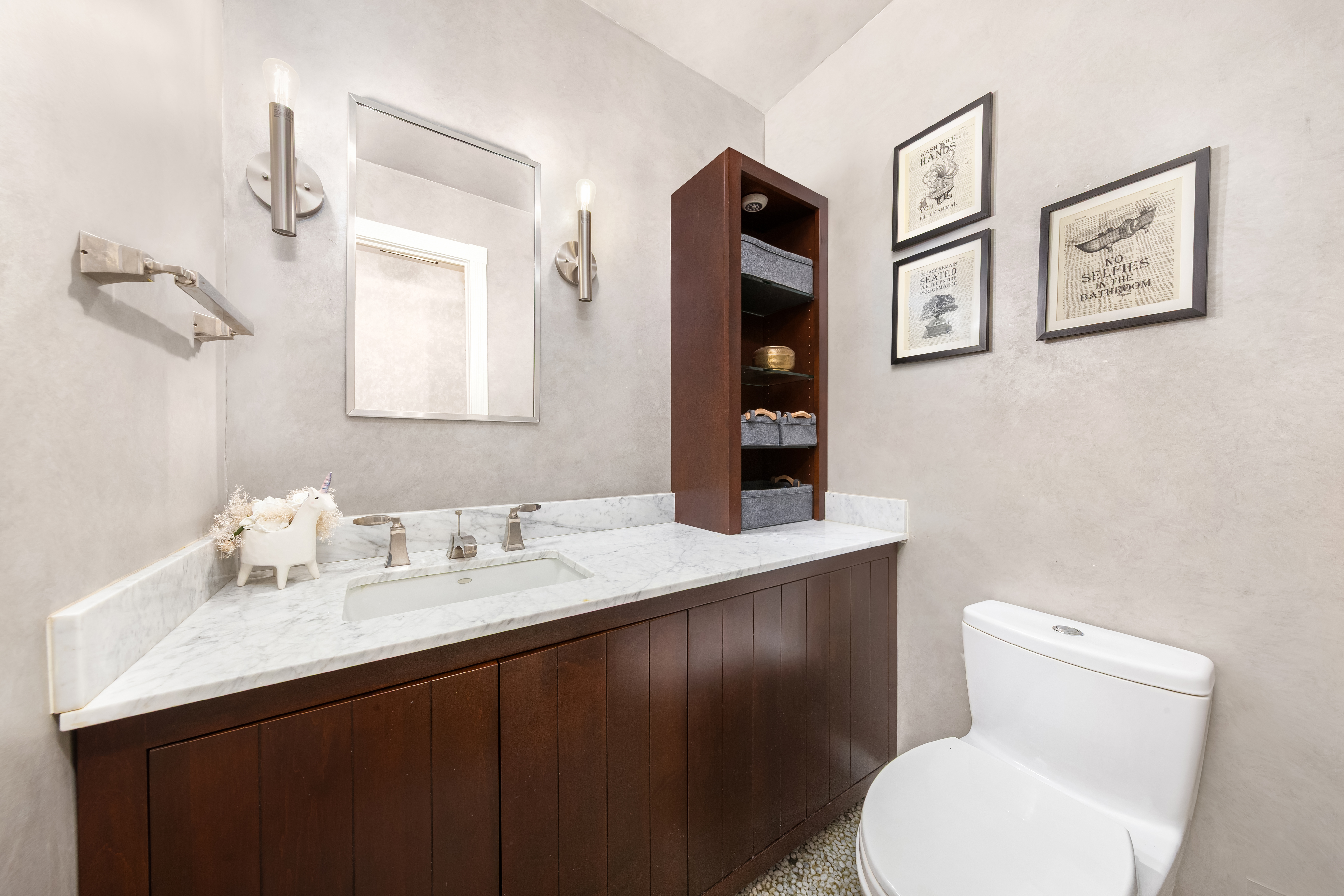 303 East 57th Street, Unit 20LA Manhattan, NY 10022 - Photo 14 of 18 a bathroom with a toilet sink and mirror