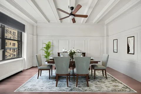a view of a dining room with furniture and window