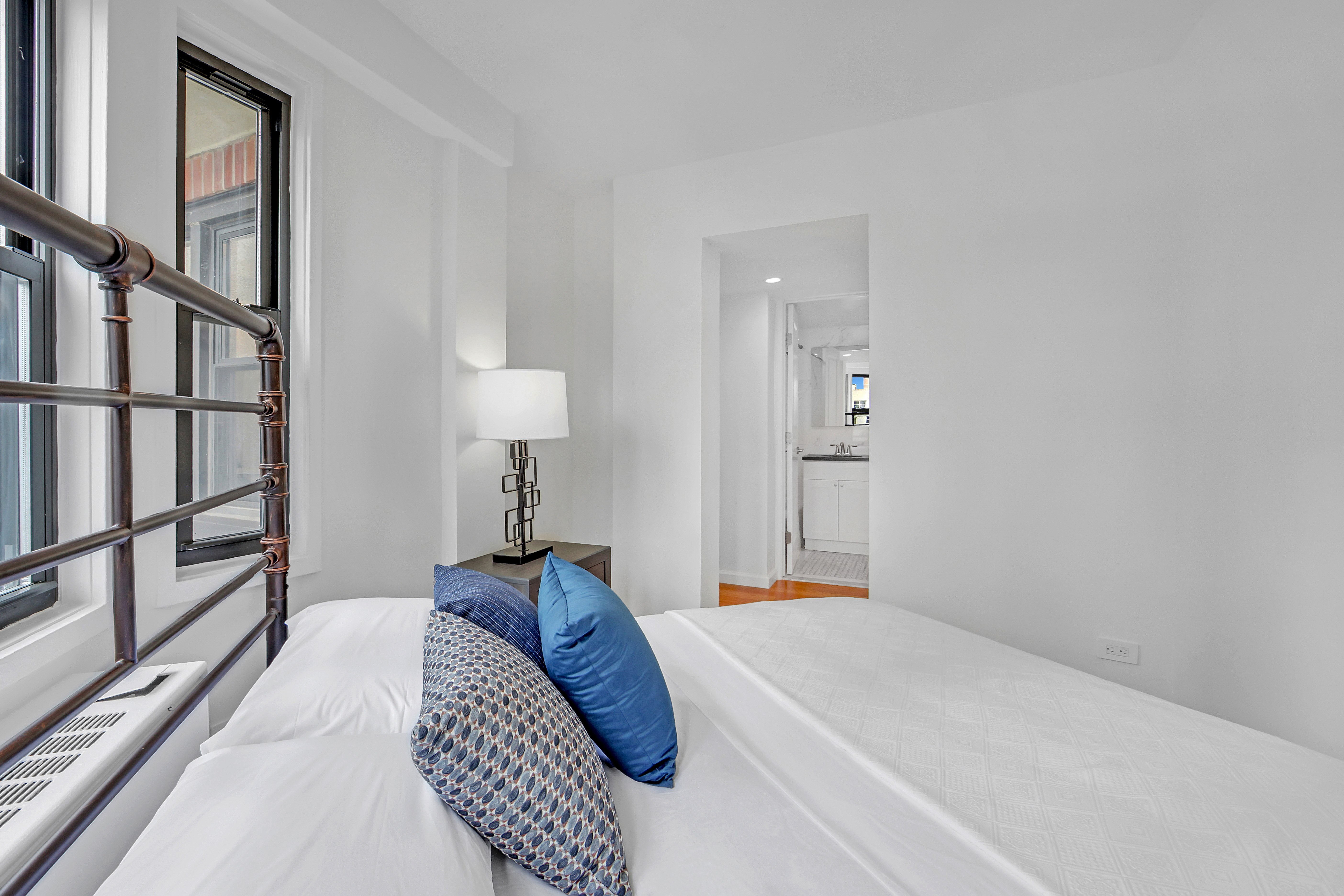 520 East 81st Street, Unit 14C Manhattan, NY 10028 - Photo 9 of 13 a bedroom with a bed and a lamp