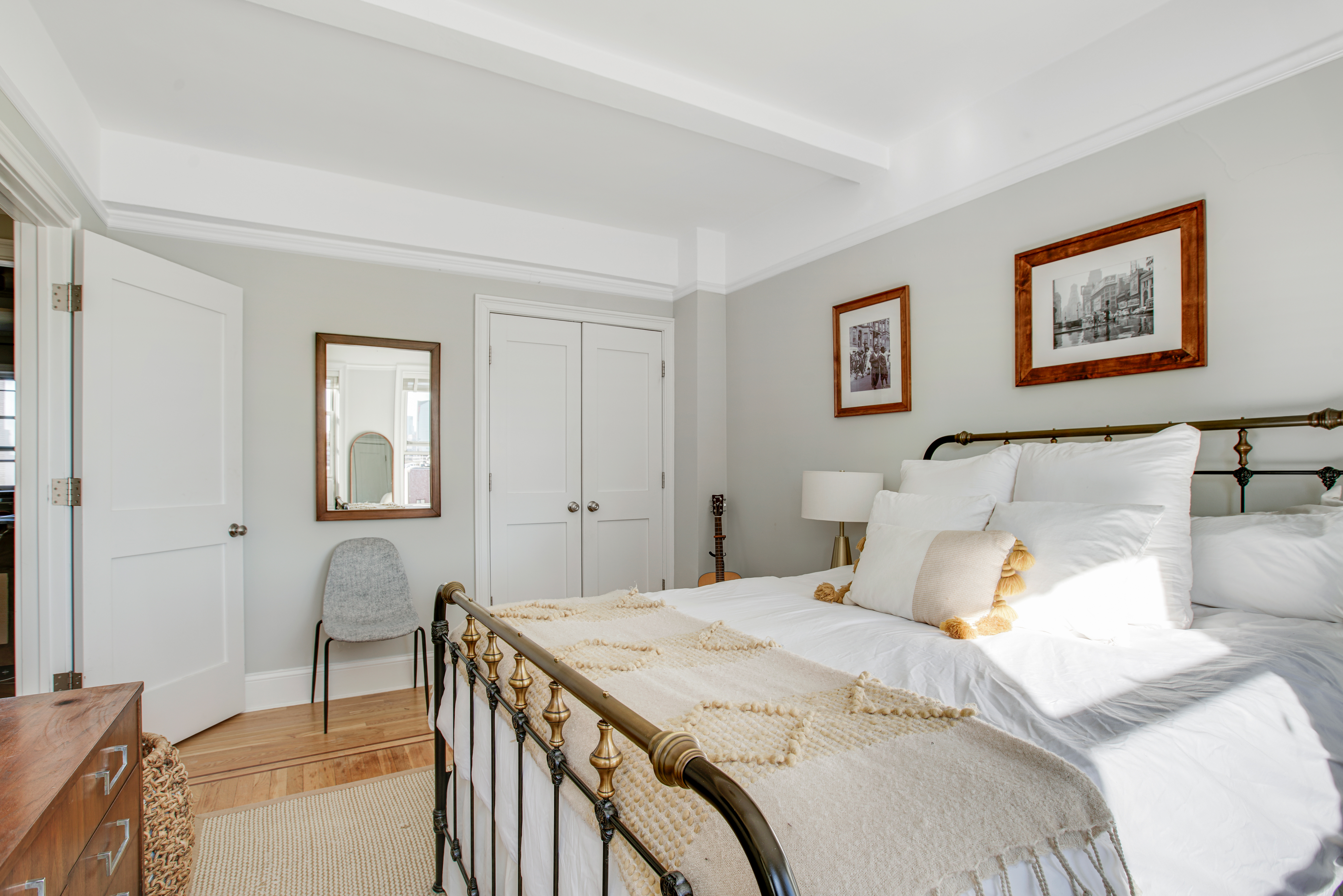 165 West 91st Street, Unit 15B Manhattan, NY 10024 - Photo 10 of 24 a bedroom with a bed and a lamp