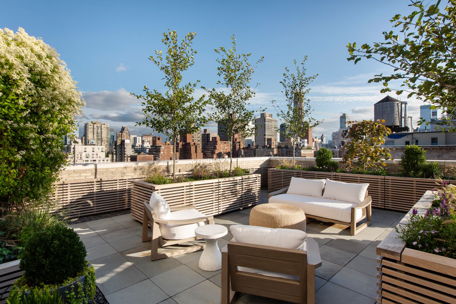 a view of a patio with couches table and chairs and potted plants