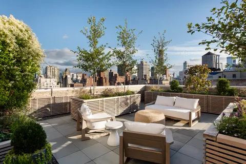 a view of a patio with couches table and chairs and potted plants