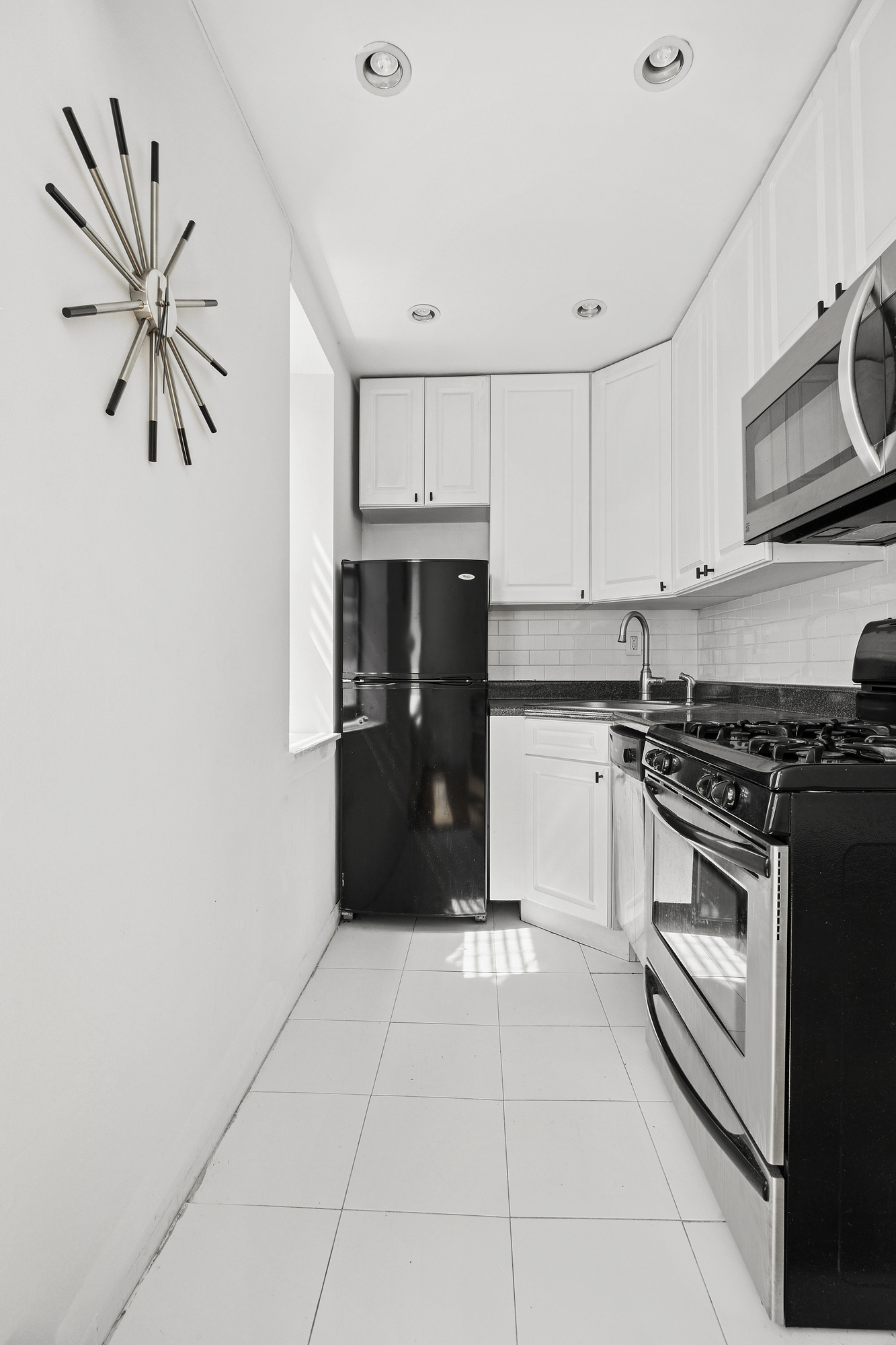 61 Lexington Avenue, Unit 5F Manhattan, NY 10010 - Photo 3 of 6 a kitchen with stainless steel appliances granite countertop a refrigerator and a stove