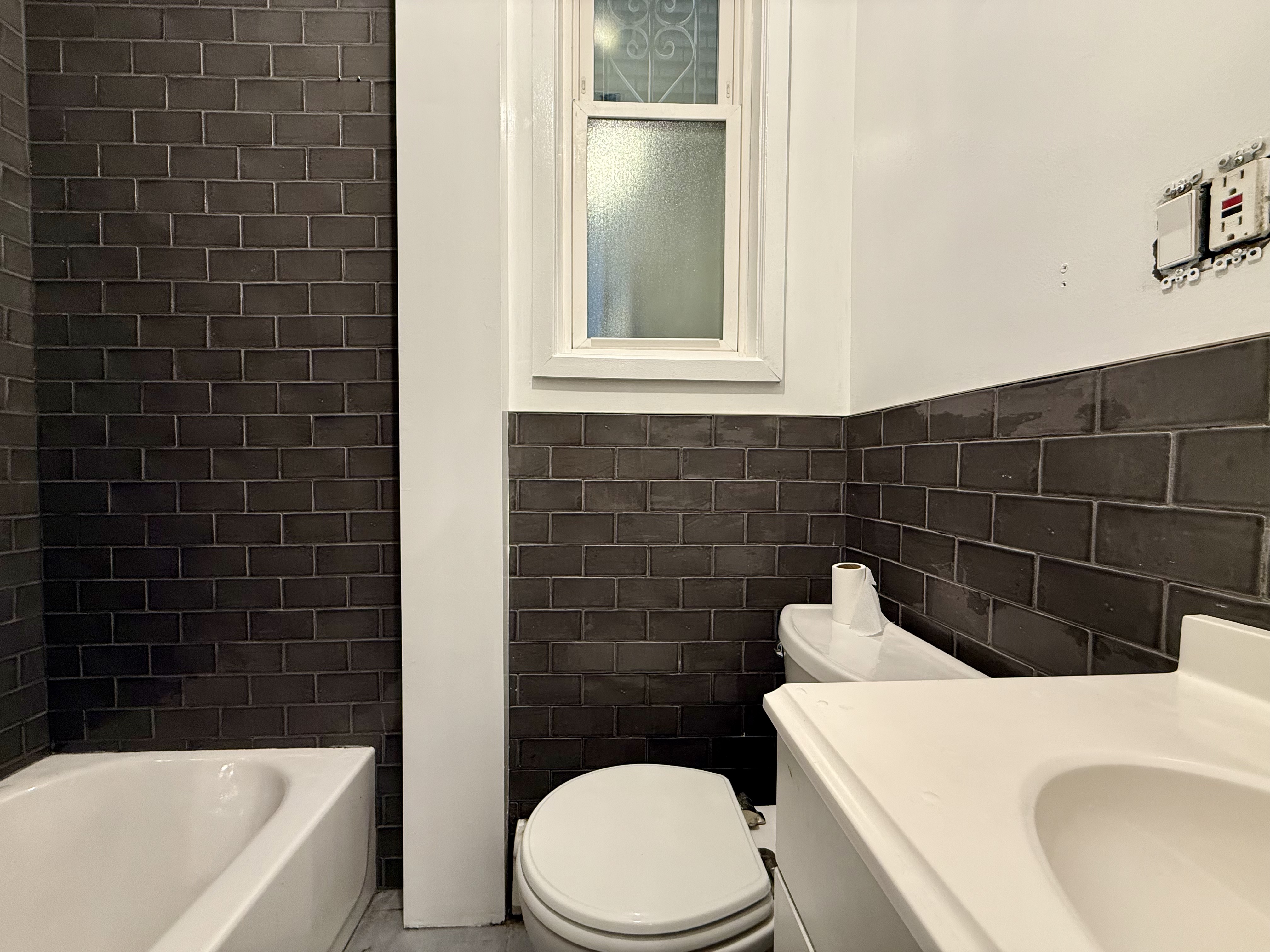 249 94th Street, Unit 1 Brooklyn, NY 11209 - Photo 7 of 13 a bathroom with a toilet a sink and bathtub