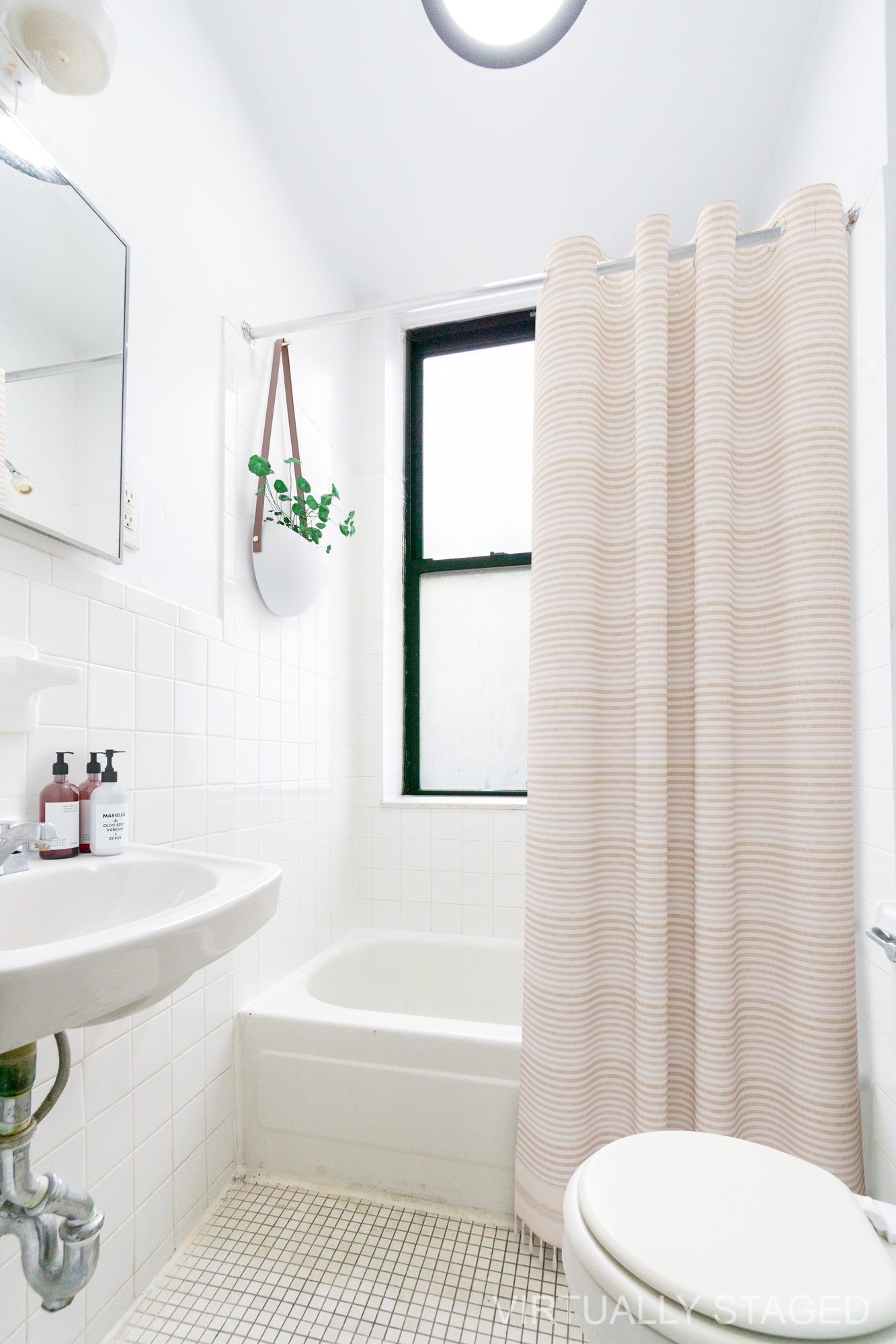215 East 5th Street, Unit 3 Manhattan, NY 10003 - Photo 19 of 25 a bathroom with a sink a toilet and tub