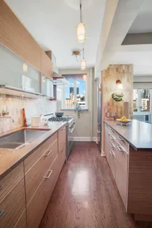 a living room with stainless steel appliances kitchen island granite countertop furniture and a large window