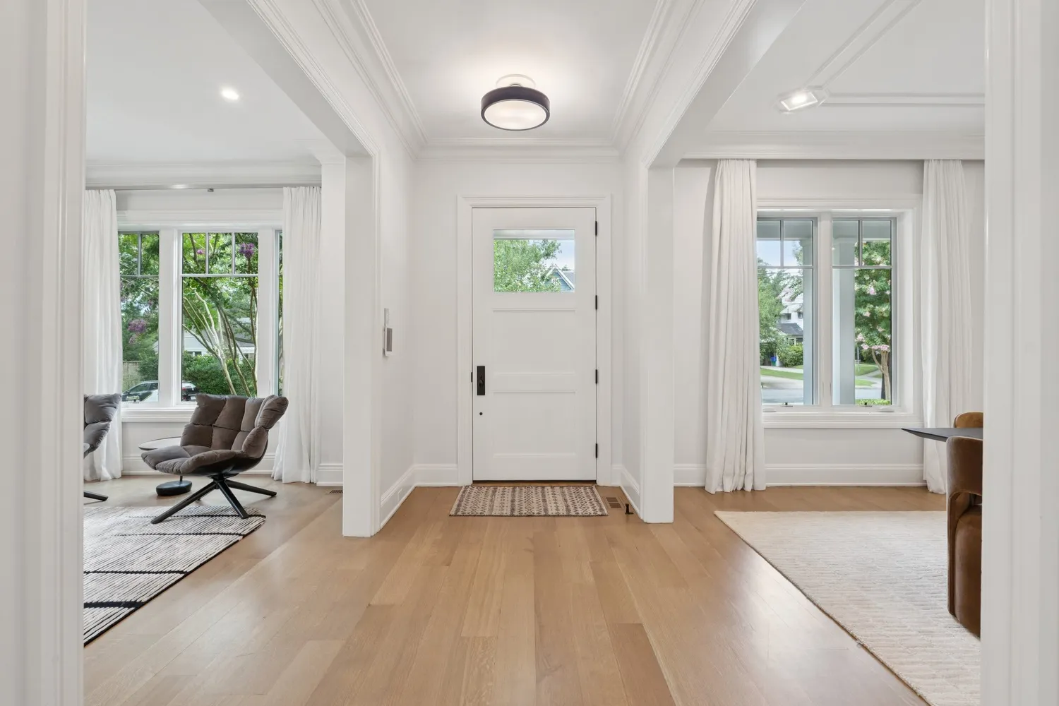 a view of livingroom with furniture wooden floor and front door