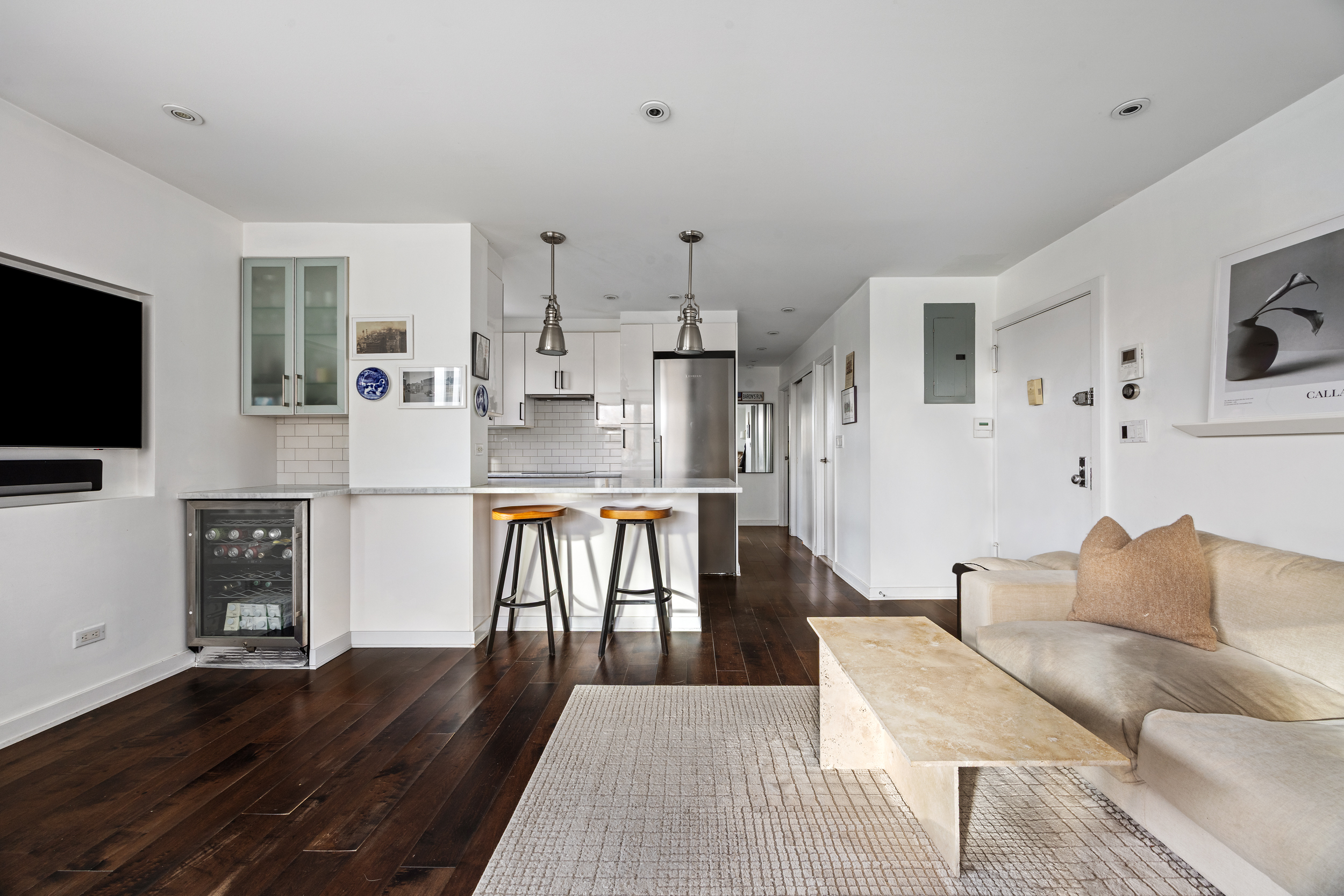 121 Morton Street, Unit 2A Manhattan, NY 10014 - Photo 2 of 9 a living room with furniture and a flat screen tv