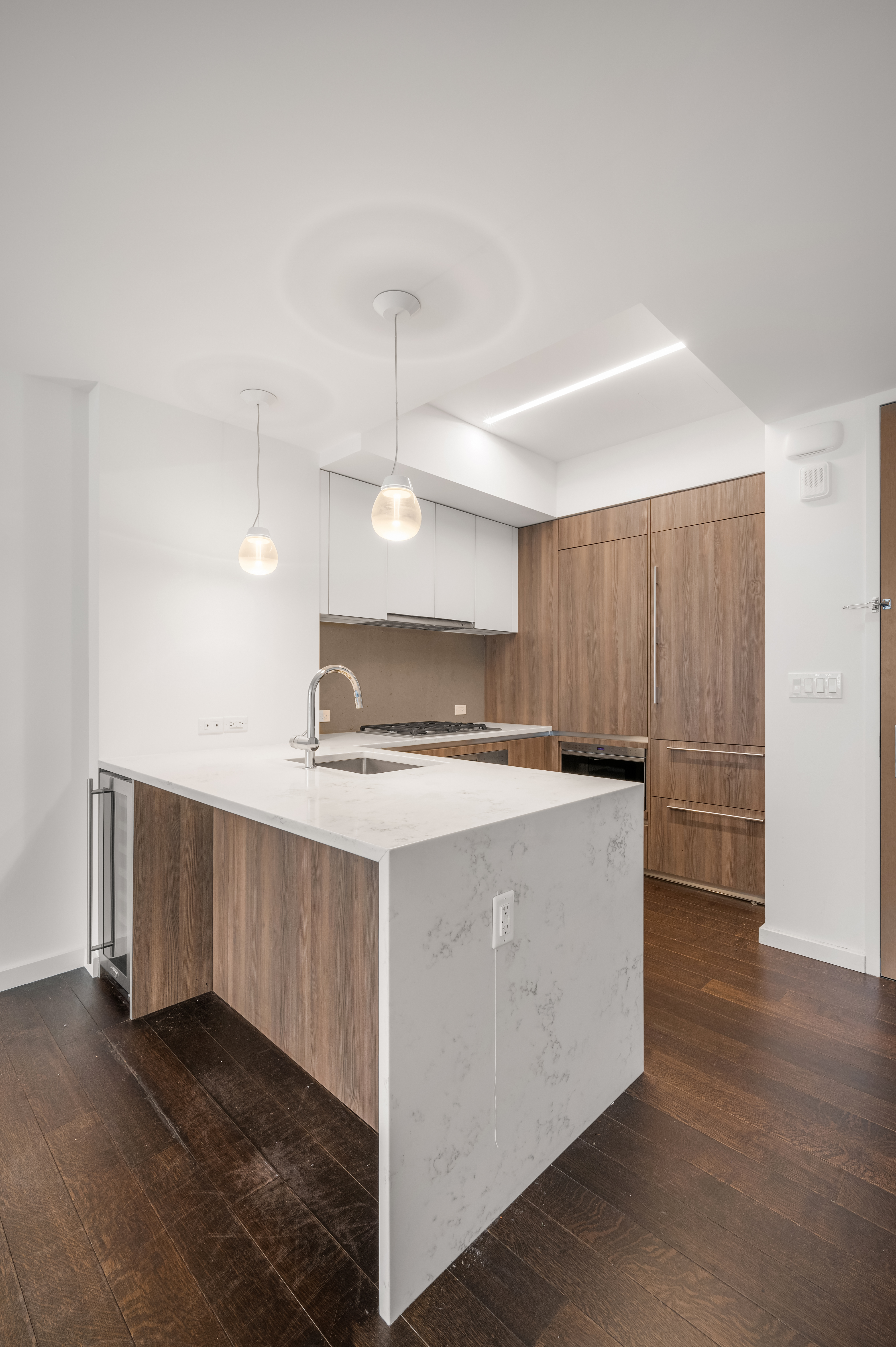 591 3rd Avenue, Unit 9C Manhattan, NY 10016 - Photo 3 of 13 a view of kitchen with cabinets and wooden floor