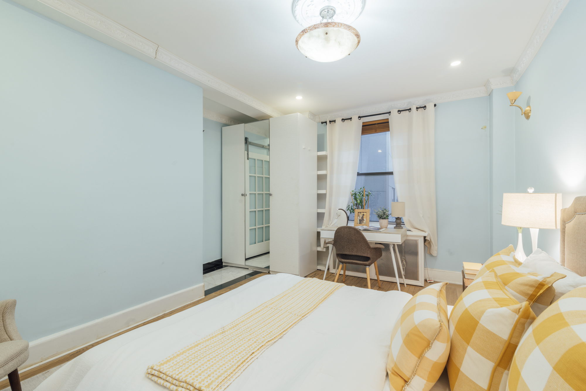 162 West 56th Street, Unit 1102 Manhattan, NY 10019 - Photo 5 of 12 a bedroom with a bed and chair