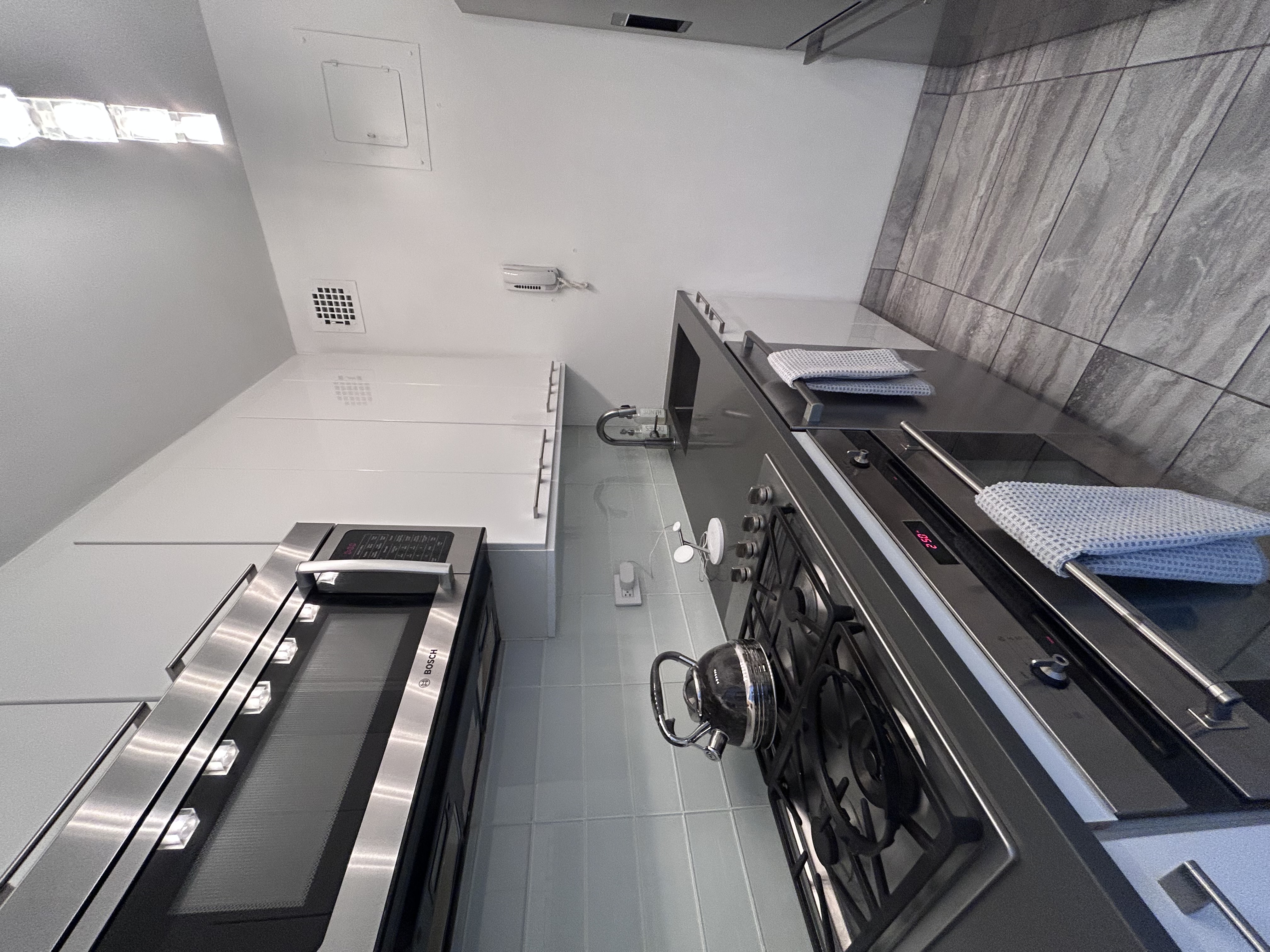 400 East 54th Street, Unit 30D Manhattan, NY 10022 - Photo 9 of 20 a kitchen with a stove and a microwave