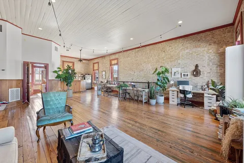 a living room with furniture and wooden floor