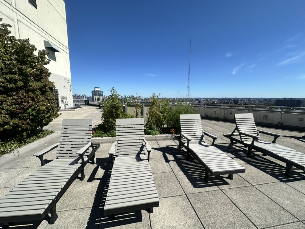 230 Ashland Place, Unit 19D Brooklyn, NY 11217 - Photo 8 of 11 a view of a terrace with wooden benches