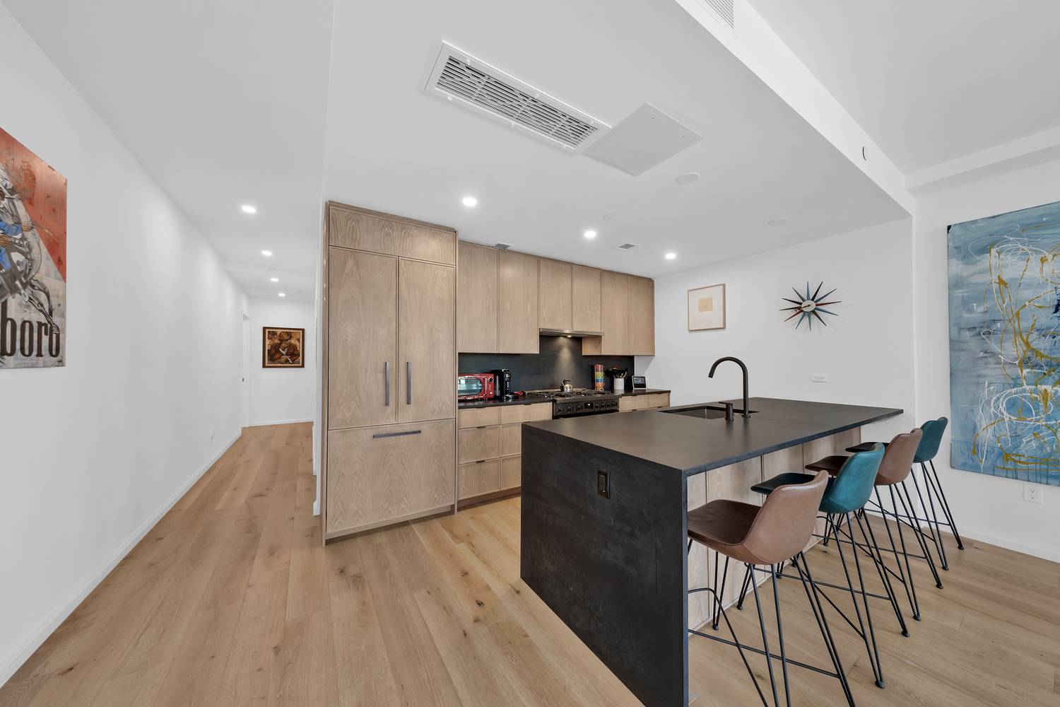 532 Clinton Avenue, Unit 5A Brooklyn, NY 11238 - Photo 5 of 11 a kitchen with stainless steel appliances granite countertop a sink a stove a refrigerator and island with wooden floor