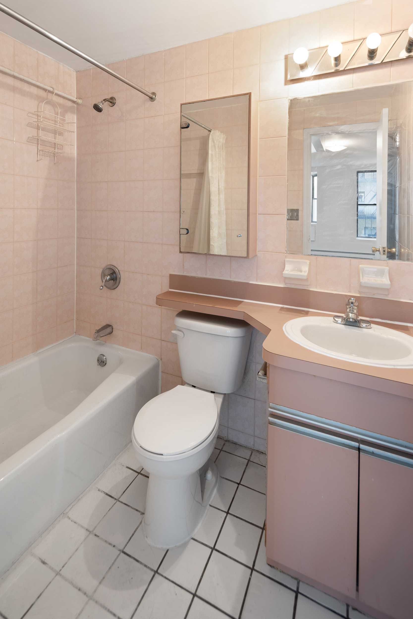 101 Allen Street, Unit 2D Manhattan, NY 10002 - Photo 4 of 4 a bathroom with a sink toilet a mirror and shower