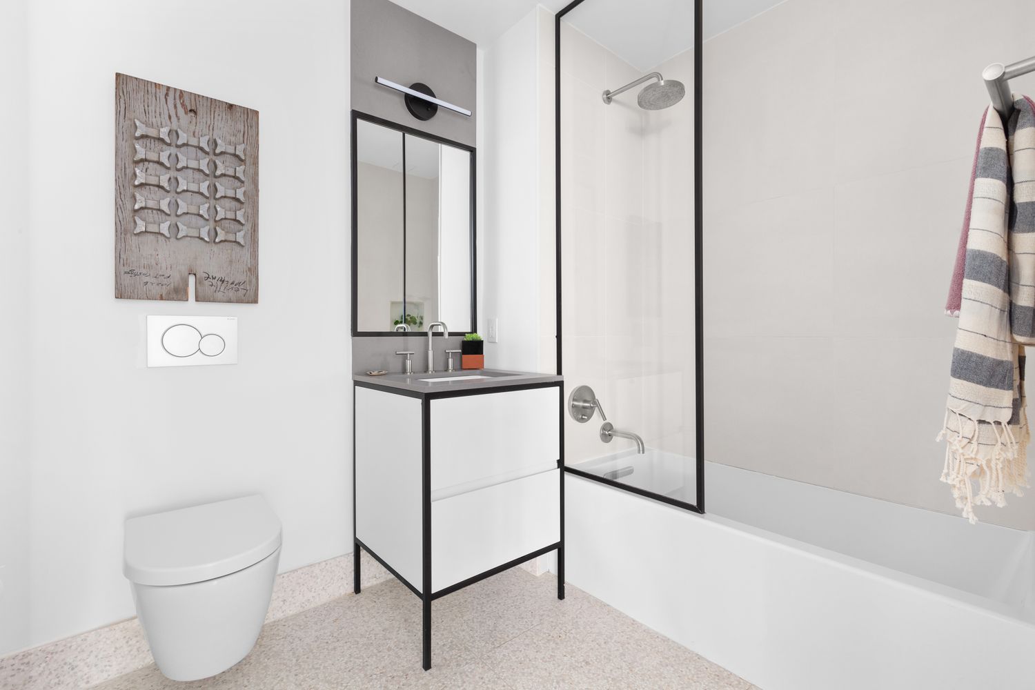 a bathroom with a toilet a sink and shower