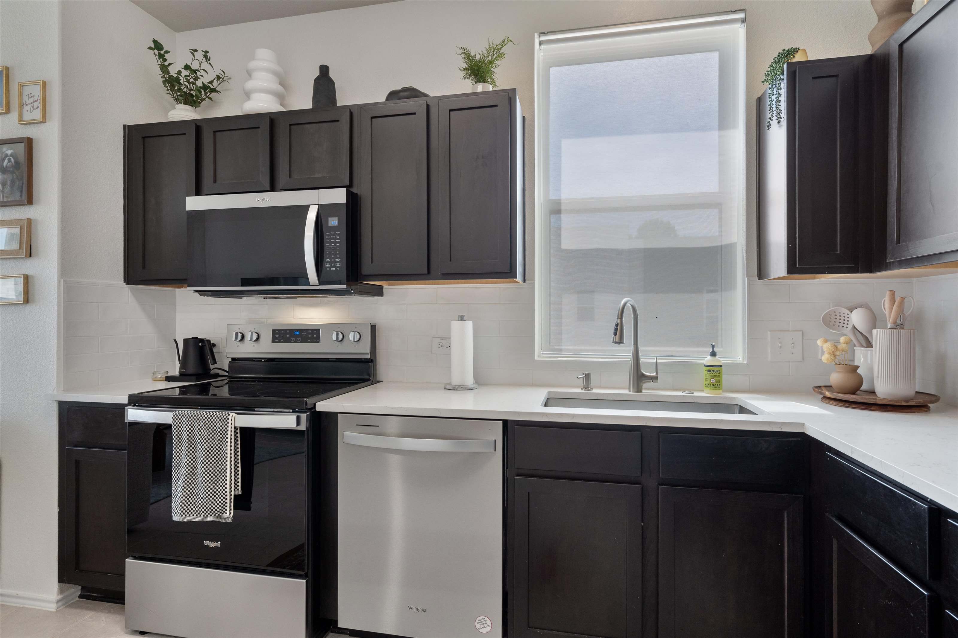 4330 Olenick Street Austin, TX 78723 - Photo 22 of 29 a kitchen with stainless steel appliances a sink stove and microwave