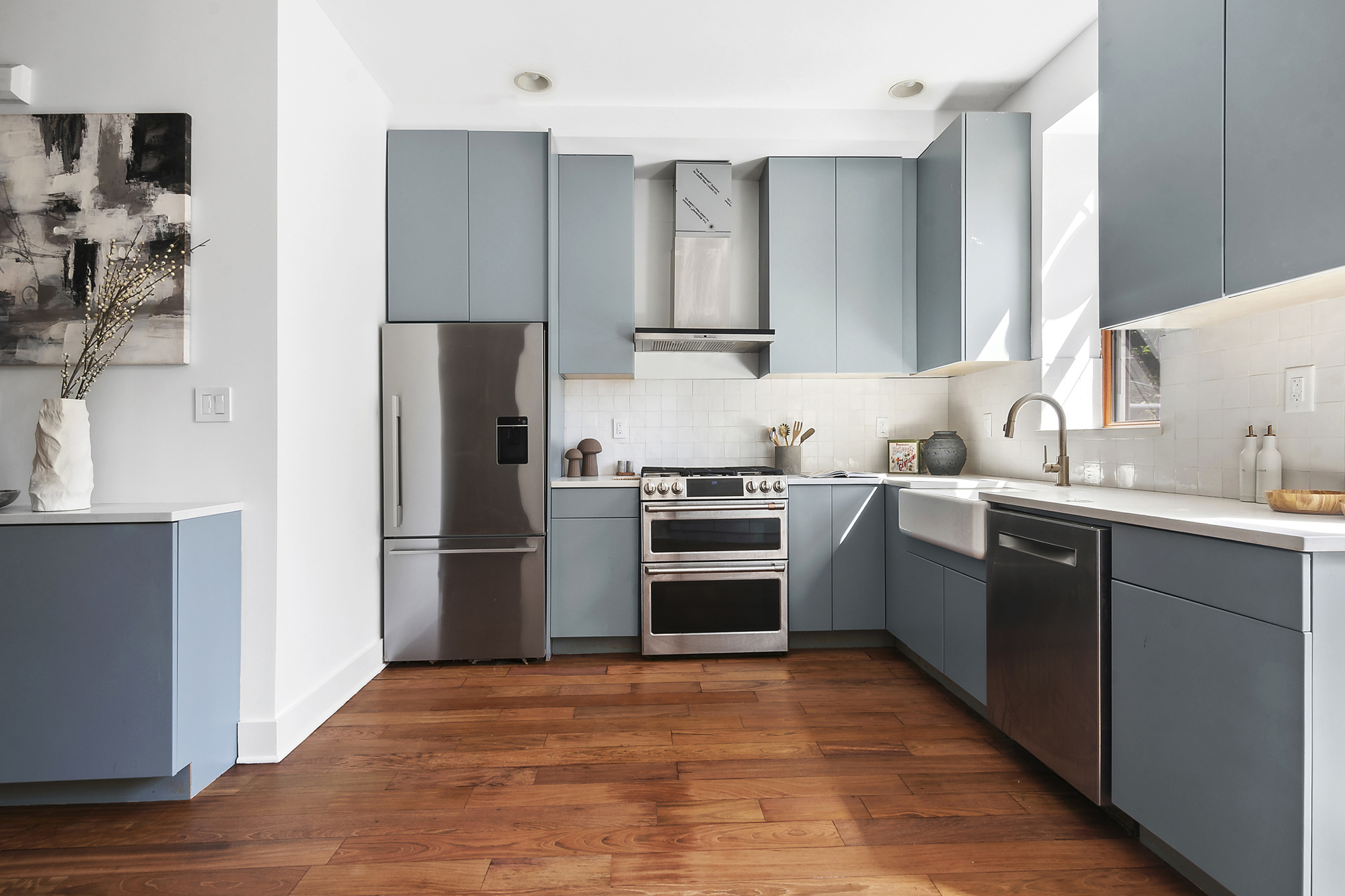 698 Halsey Street Brooklyn, NY 11233 - Photo 3 of 13 a kitchen with a sink cabinets and stainless steel appliances