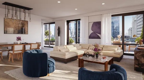 a living room with couches and a large mirror with wooden floor