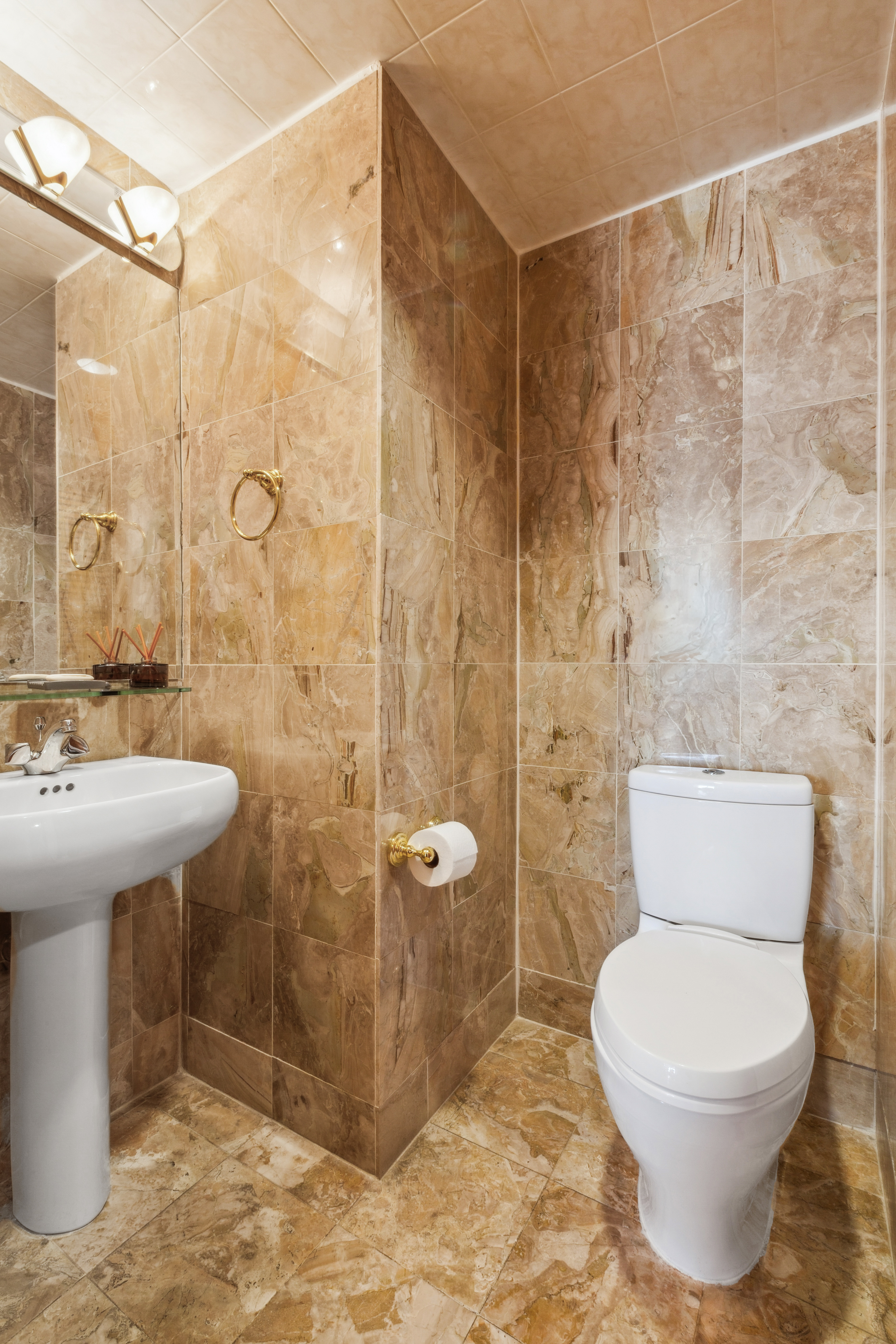 160 West 66th Street, Unit 23D Manhattan, NY 10023 - Photo 6 of 10 a bathroom with a toilet sink and shower