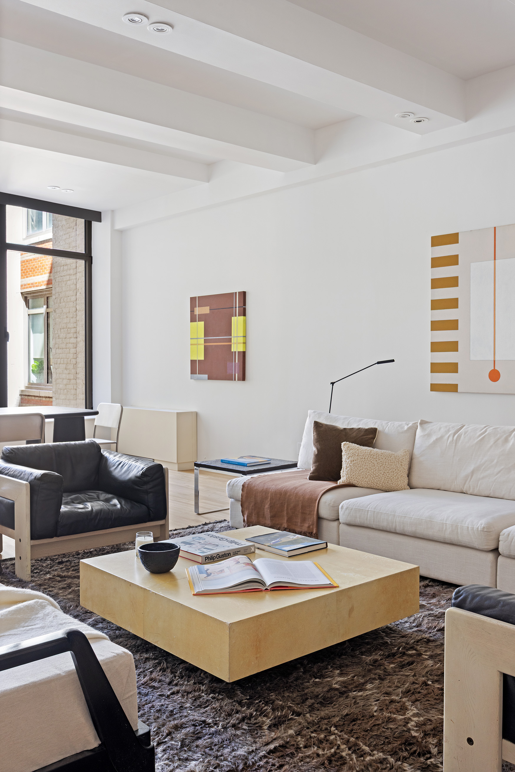 252 7th Avenue, Unit 9R Manhattan, NY 10001 - Photo 4 of 23 a living room with furniture and a couch