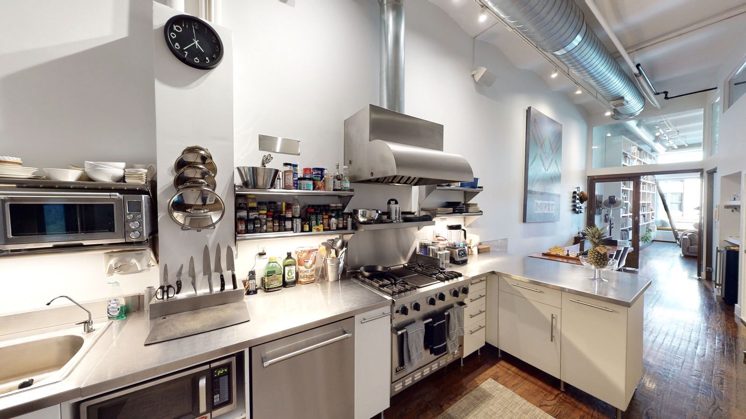 382 Lafayette Street, Unit 2 Manhattan, NY 10003 - Photo 6 of 19 a kitchen with stainless steel appliances granite countertop a sink dishwasher stove and white cabinets with wooden floor
