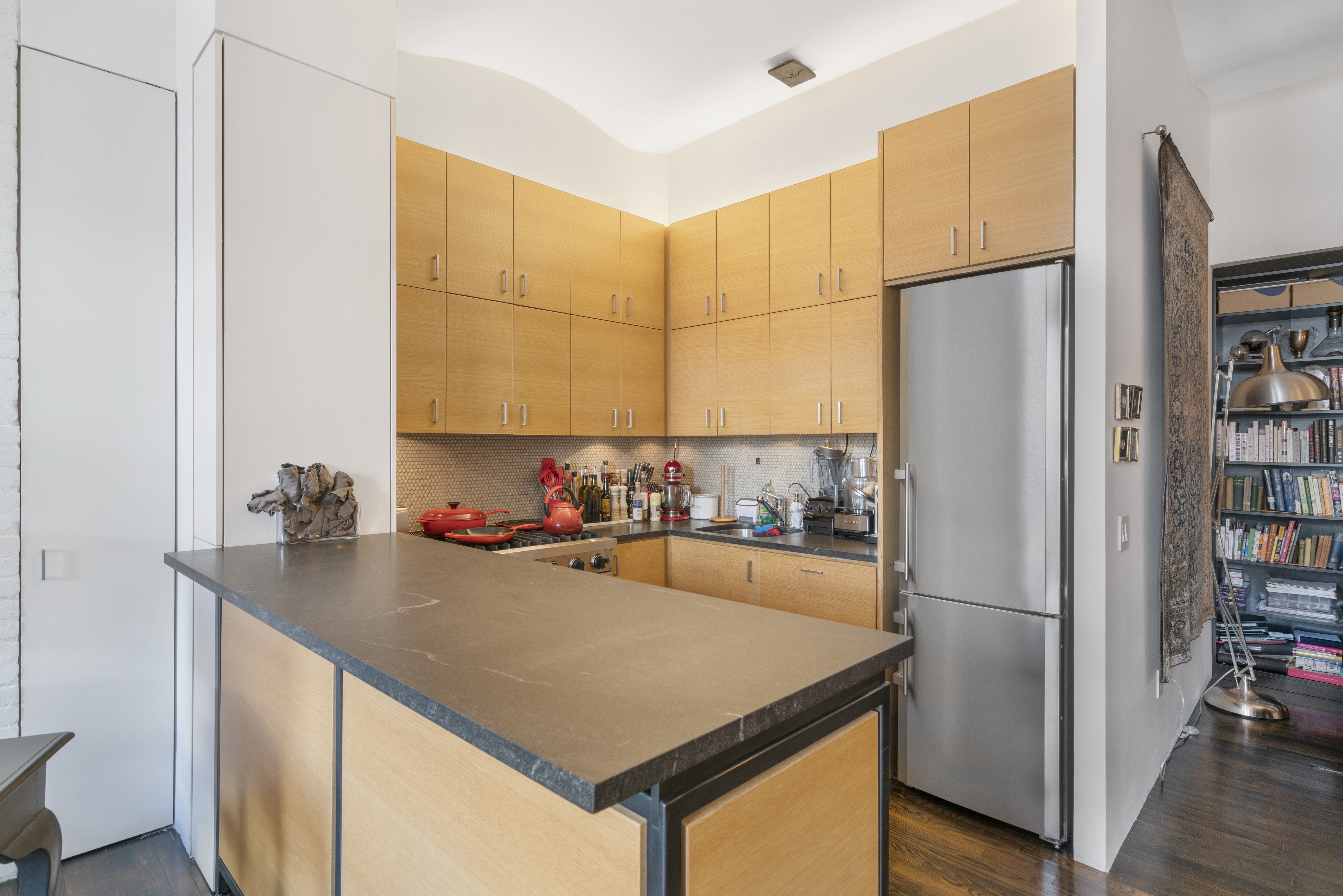 312 East 23rd Street, Unit 7B Manhattan, NY 10010 - Photo 3 of 14 a kitchen with refrigerator and cabinets