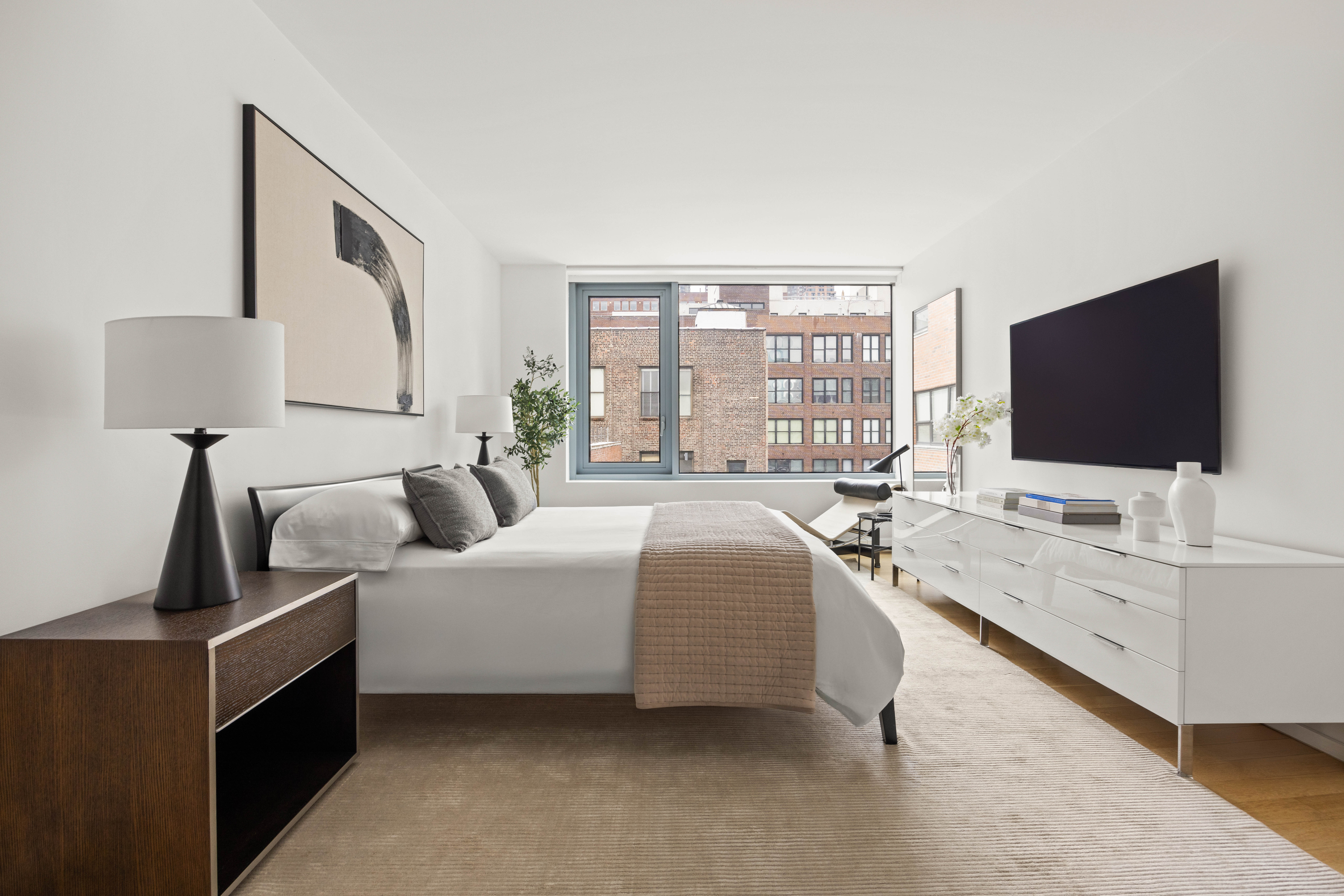 425 West 53rd Street, Unit 604 Manhattan, NY 10019 - Photo 7 of 12 a living room with furniture and a flat screen tv