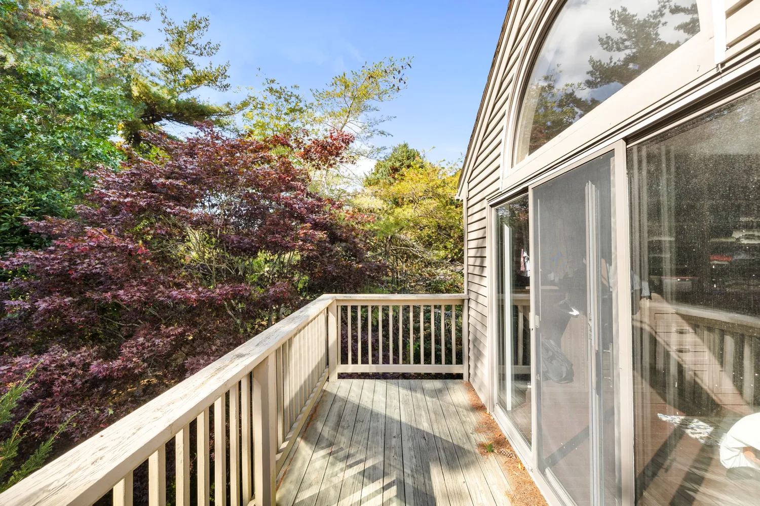 a view of a balcony with wooden fence