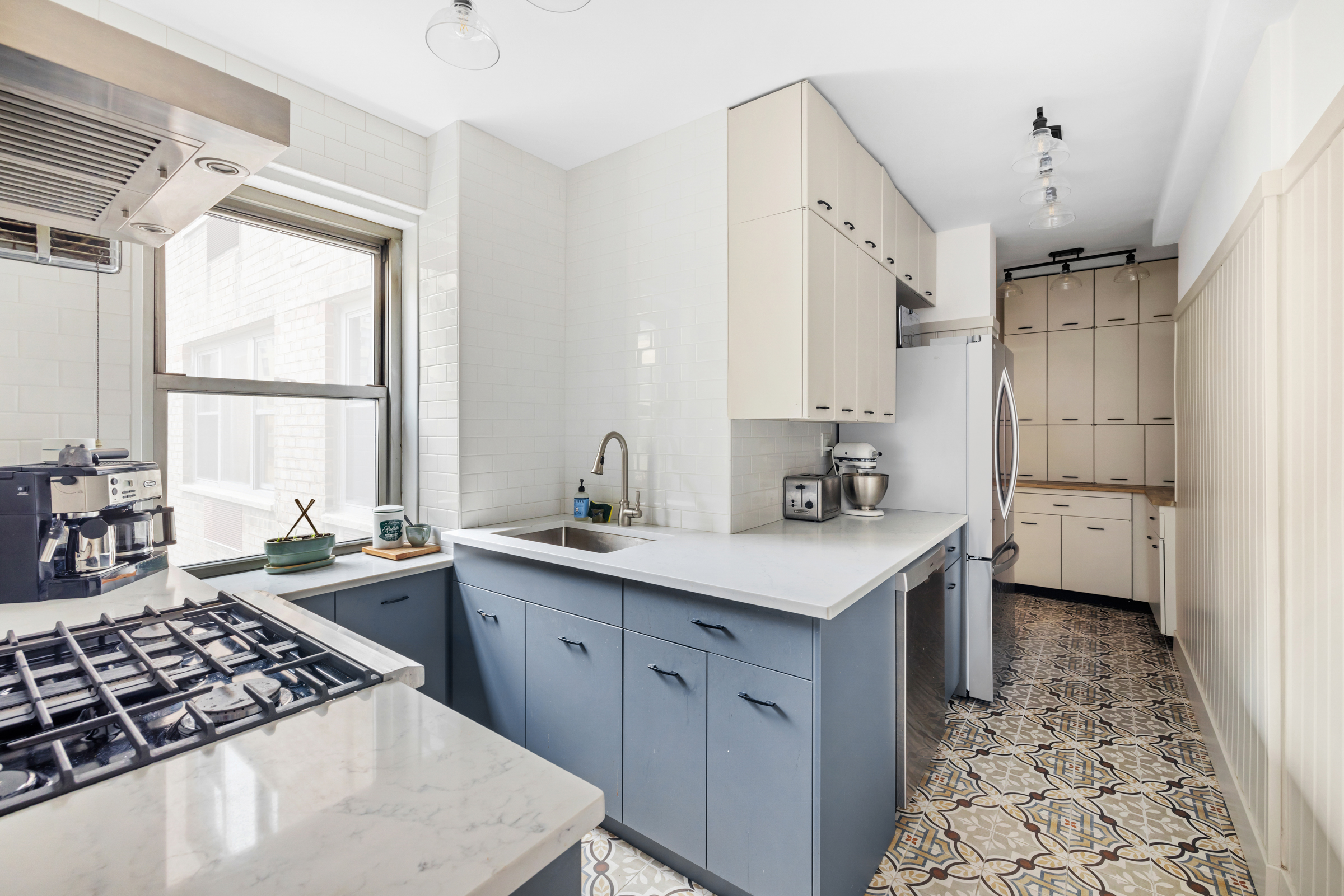16 Sutton Place, Unit 11A Manhattan, NY 10022 - Photo 5 of 19 a kitchen with a sink stove and cabinets