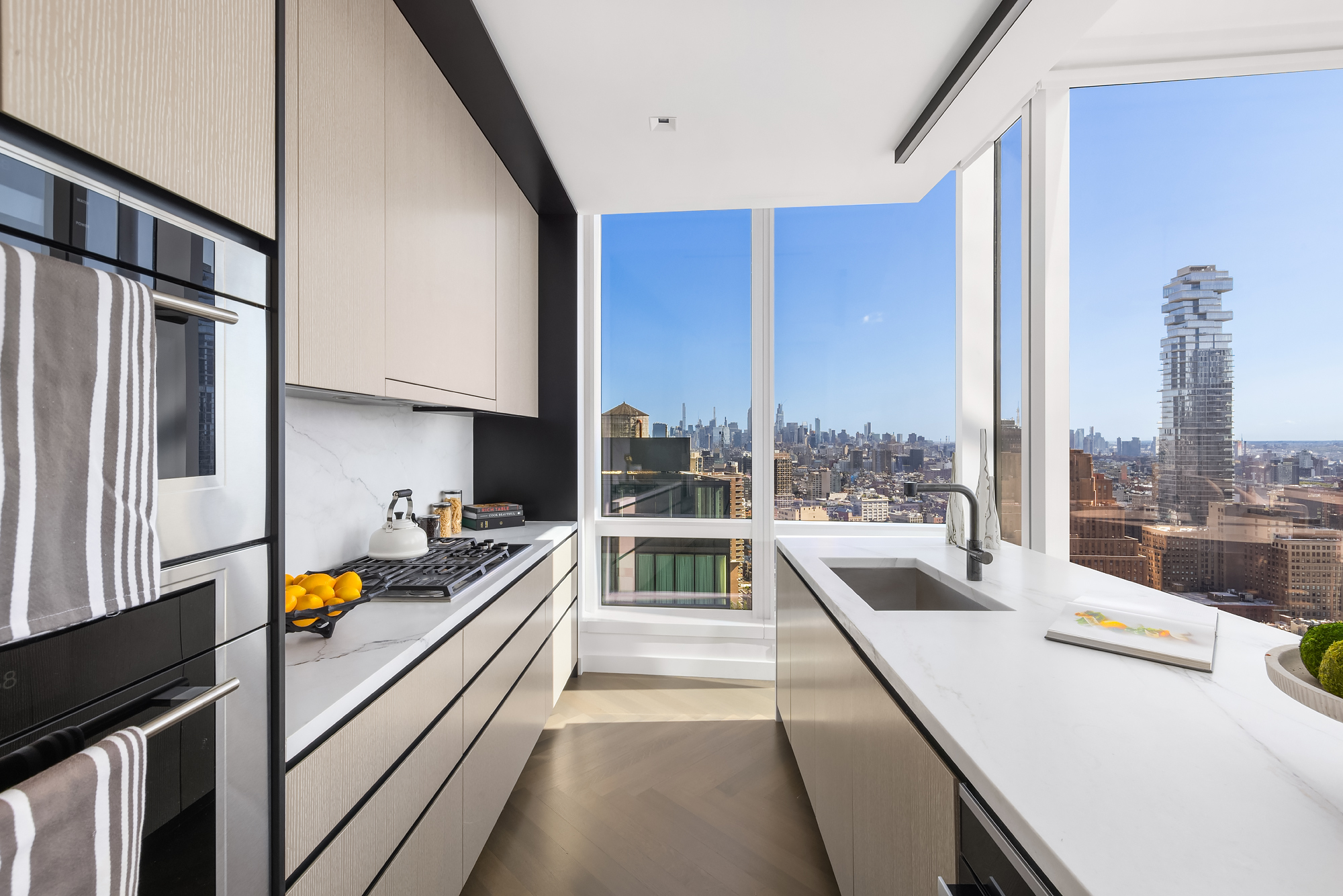 111 Murray Street, Unit 38A Manhattan, NY 10007 - Photo 8 of 29 a kitchen with stainless steel appliances a large counter top a stove top oven