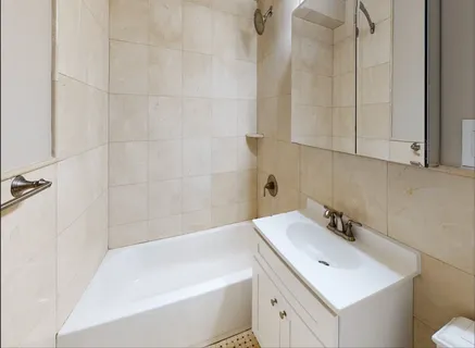 a bathroom with a sink a toilet and bathtub